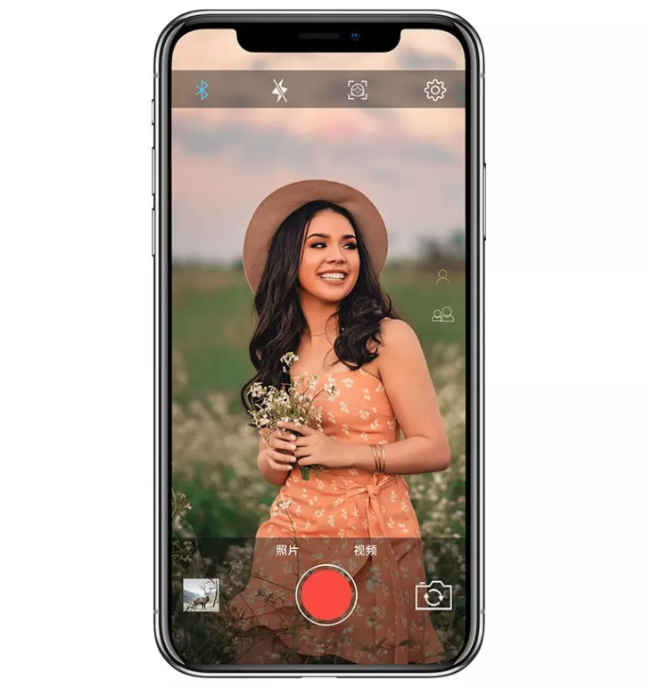 A Phone recording a women in a flower field